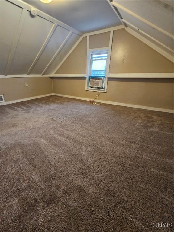 802 W End Ave, Wilna, NY 13619 - additional living space featuring cooling unit, vaulted ceiling, carpet, and baseboards