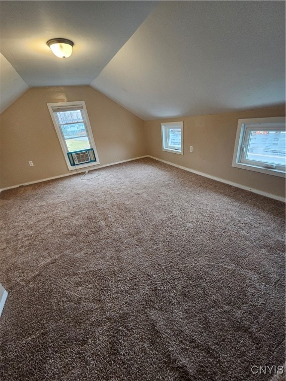 bonus room featuring carpet, plenty of natural light, and lofted ceiling