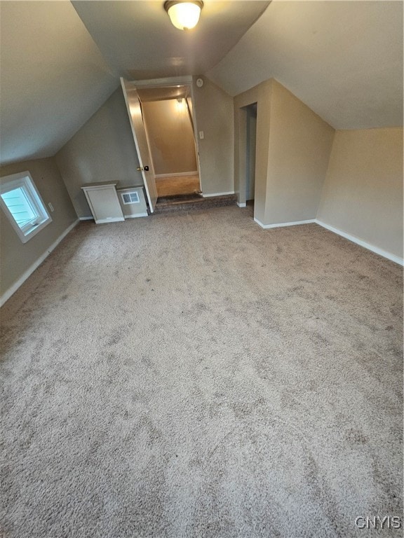 bonus room featuring carpet floors and vaulted ceiling