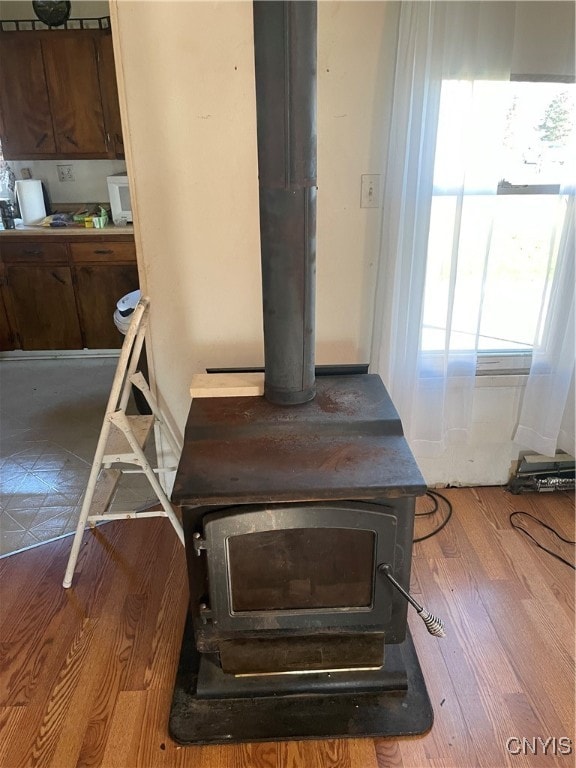 room details featuring hardwood / wood-style flooring and a wood stove