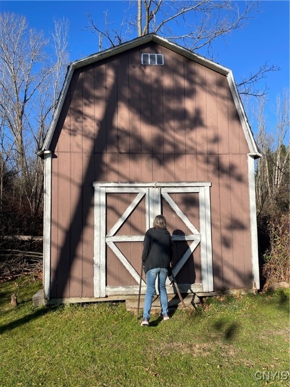 view of outbuilding with a lawn