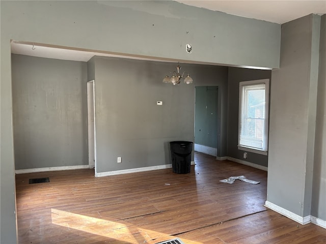 107 E Main St, Hornell, NY 14843 - unfurnished dining area with a chandelier, wood finished floors, and baseboards