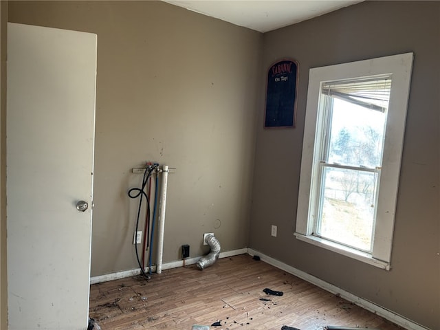 laundry room with hardwood / wood-style floors and washer hookup