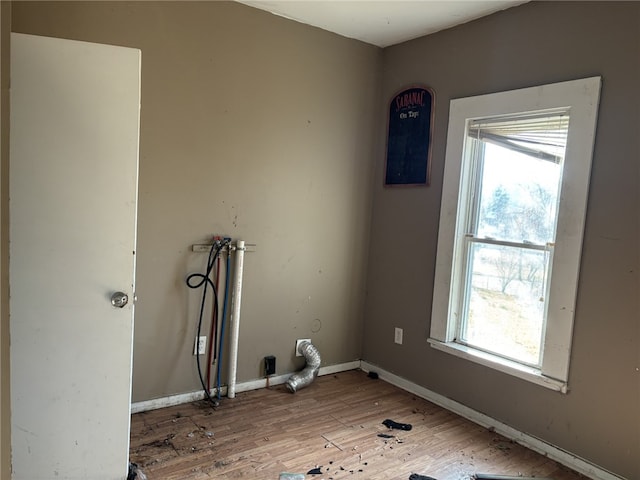 107 E Main St, Hornell, NY 14843 - laundry area featuring light wood-style flooring, hookup for a washing machine, and baseboards