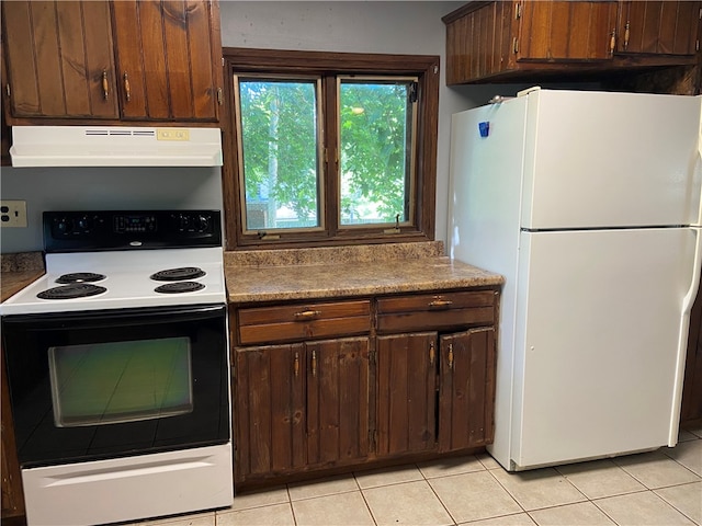 kitchen featuring dark brown cabinetry, light tile patterned floors, white appliances, and ventilation hood