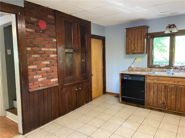 kitchen with dishwasher, light tile patterned floors, and sink