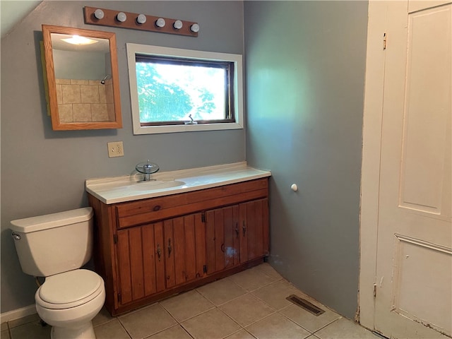 bathroom with tile patterned flooring, vanity, and toilet