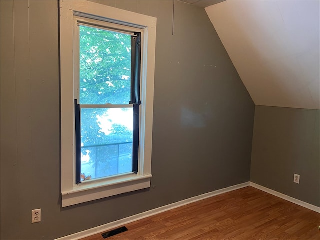 bonus room featuring wood-type flooring and lofted ceiling