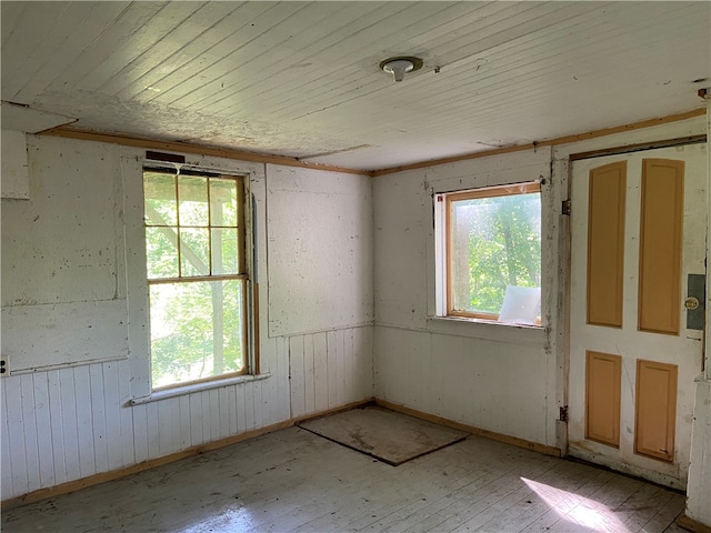 spare room with plenty of natural light, light hardwood / wood-style floors, and wood ceiling