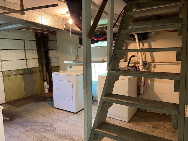 basement featuring washer / dryer and light hardwood / wood-style floors