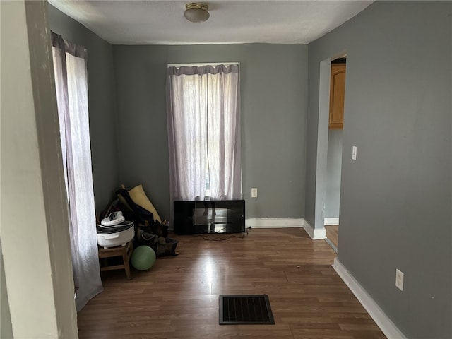 interior space featuring a textured ceiling and dark hardwood / wood-style floors