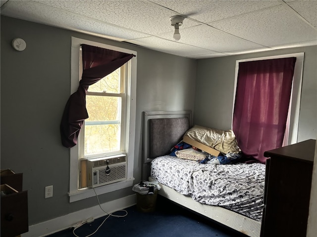 bedroom featuring a paneled ceiling and cooling unit