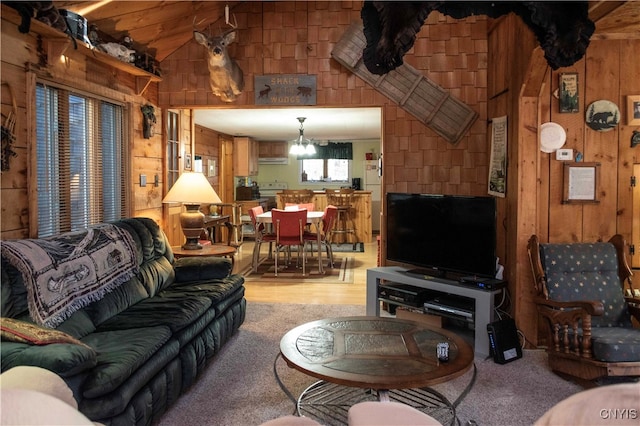 living room with hardwood / wood-style flooring, wooden walls, and vaulted ceiling