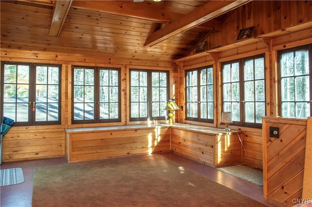 unfurnished sunroom with lofted ceiling with beams, wooden ceiling, and french doors