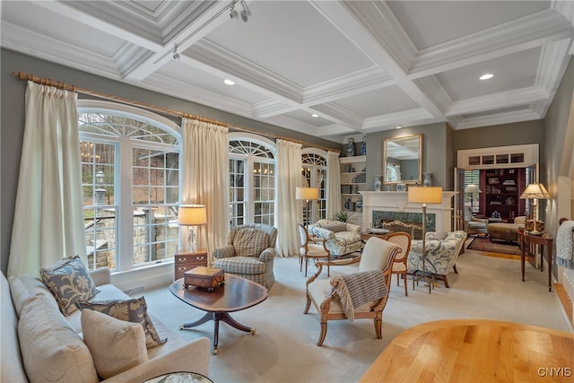 living room featuring beam ceiling, ornamental molding, coffered ceiling, and a premium fireplace