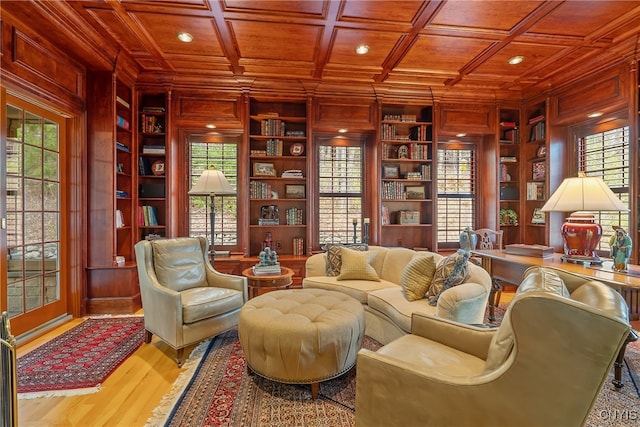 sitting room with built in shelves, a wealth of natural light, and wood ceiling