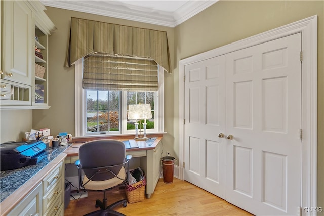 home office with light hardwood / wood-style floors and ornamental molding