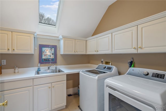 laundry area with washer and dryer, cabinets, light tile patterned floors, and sink