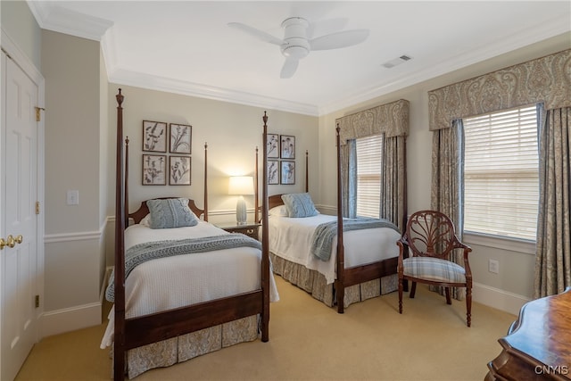 carpeted bedroom with ceiling fan and crown molding