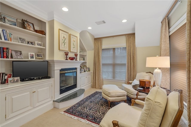 living room featuring built in shelves, carpet floors, and crown molding