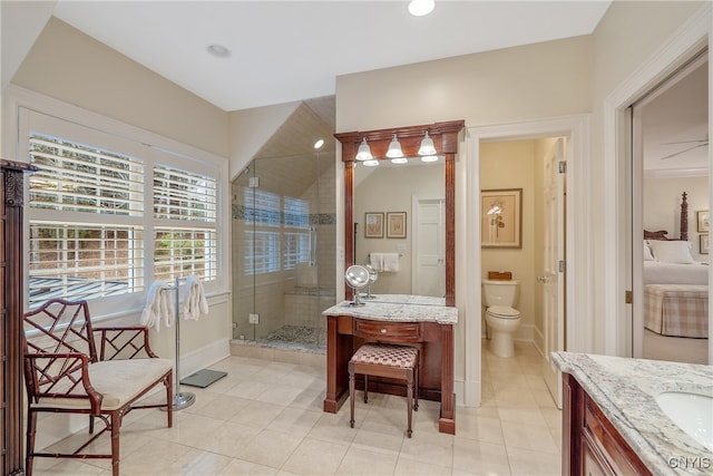 bathroom with tile patterned floors, vanity, toilet, and an enclosed shower