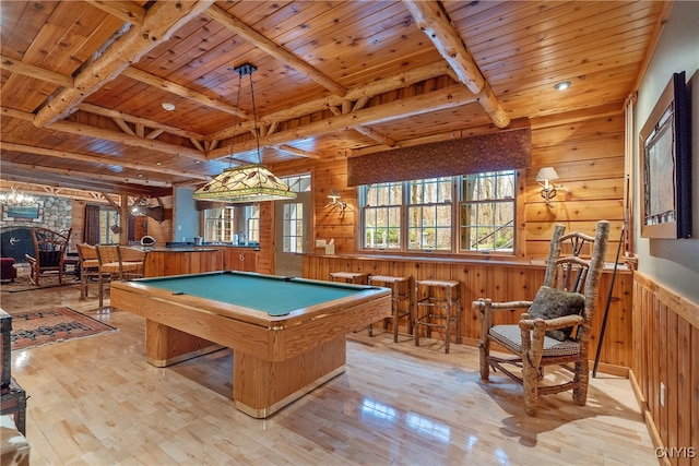 game room with wood walls, light hardwood / wood-style floors, wooden ceiling, and pool table