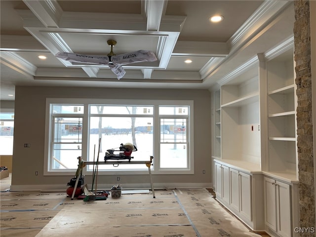 interior space with built in features, a water view, light hardwood / wood-style flooring, and crown molding