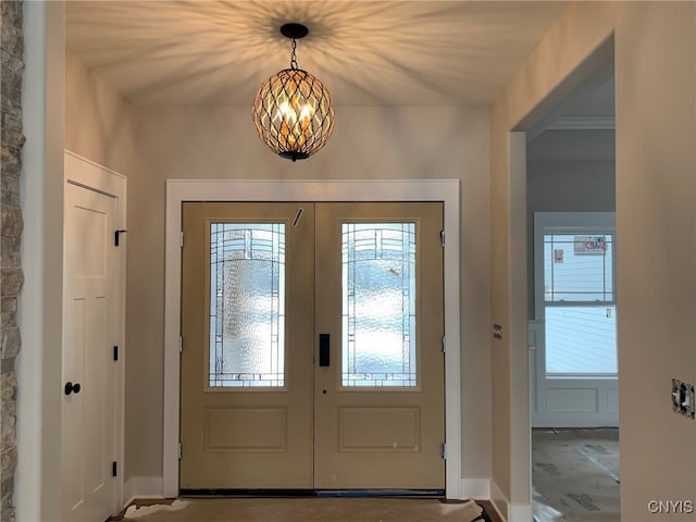 entrance foyer featuring french doors and a chandelier