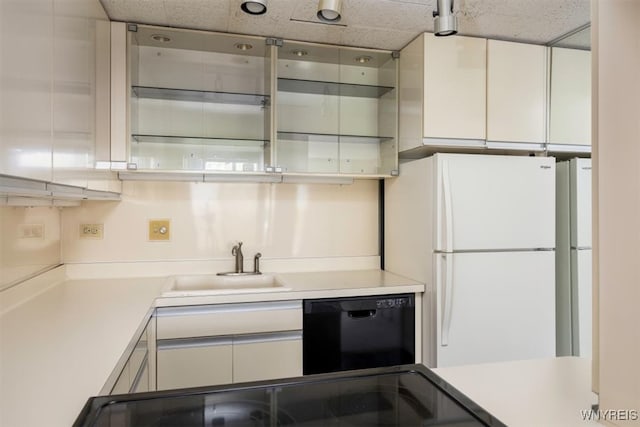 kitchen with white cabinetry, sink, black dishwasher, white refrigerator, and a paneled ceiling