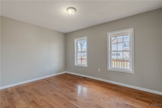 unfurnished room with light wood-type flooring