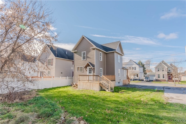 rear view of property with a yard