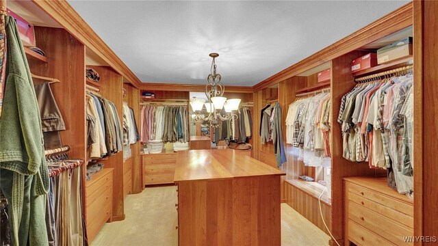 spacious closet featuring light colored carpet and a notable chandelier