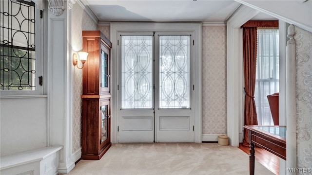 carpeted foyer entrance with french doors and ornamental molding