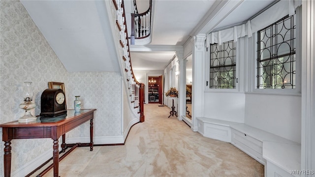 hallway with light carpet and crown molding