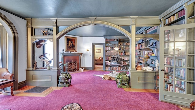 29 Willets Ave, Amity, NY 14813 - carpeted living area featuring a fireplace, arched walkways, and crown molding