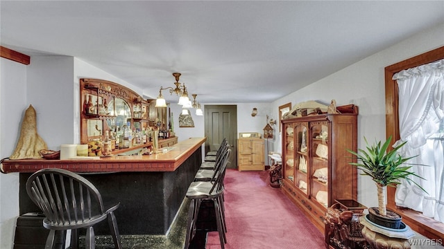 bar with carpet flooring and hanging light fixtures