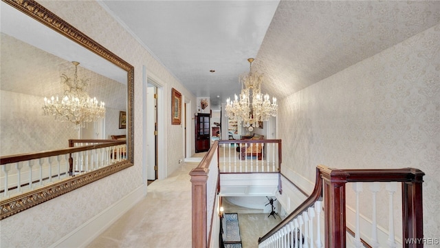 hall featuring light carpet, vaulted ceiling, and an inviting chandelier