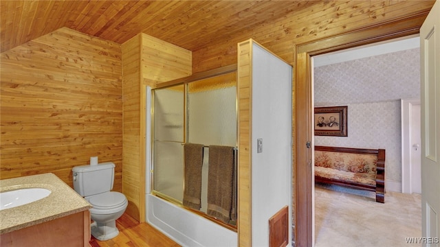 29 Willets Ave, Amity, NY 14813 - bathroom with toilet, vaulted ceiling, vanity, wooden walls, and shower / bath combination with glass door