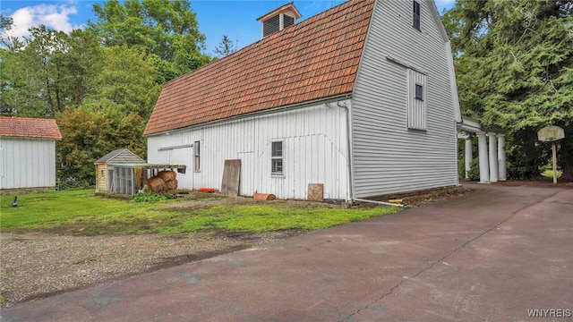 view of property exterior with an outbuilding