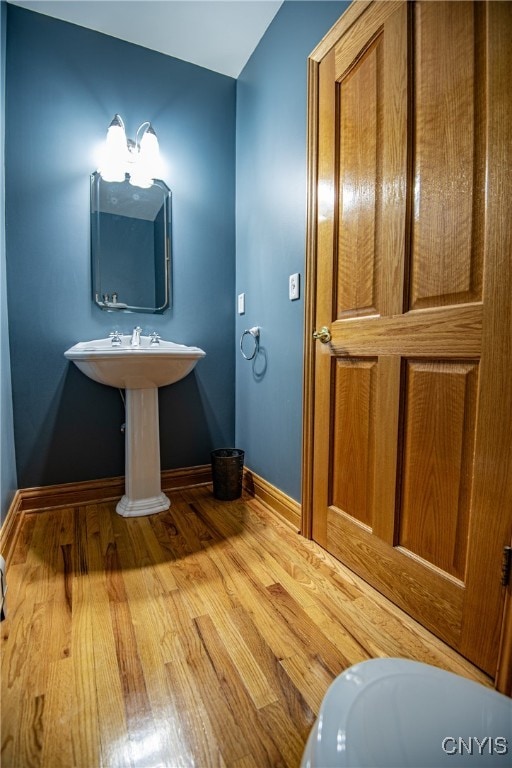 bathroom with hardwood / wood-style flooring