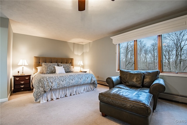 bedroom with ceiling fan, light carpet, and a baseboard radiator