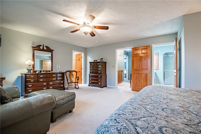 bedroom featuring ceiling fan, light colored carpet, and a textured ceiling