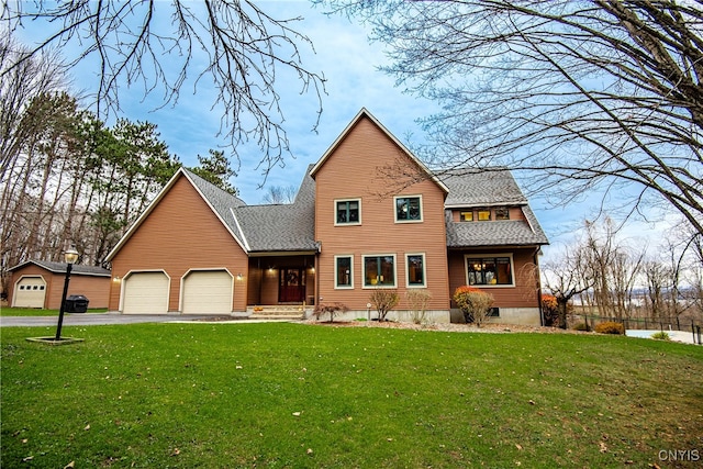 view of front of house with a garage and a front lawn