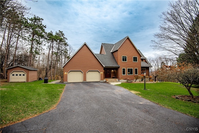 view of front property with a front yard and an outbuilding