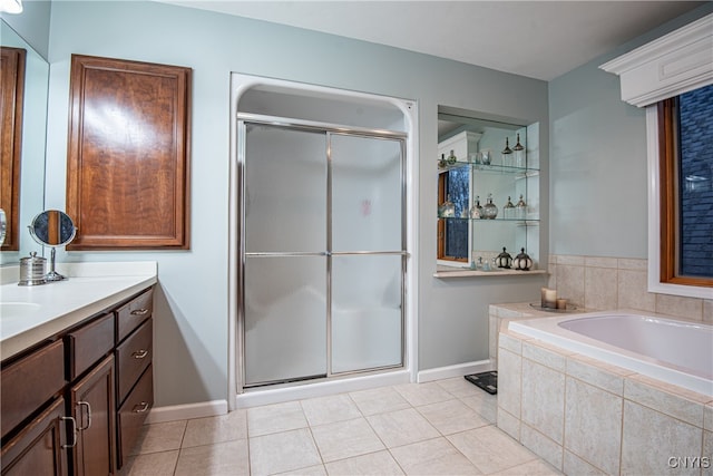 bathroom featuring tile patterned flooring, shower with separate bathtub, and vanity