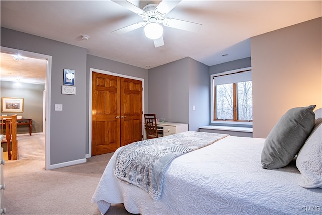 carpeted bedroom with ceiling fan and a closet