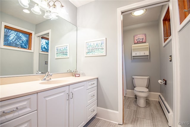 bathroom with vanity, a baseboard radiator, and toilet