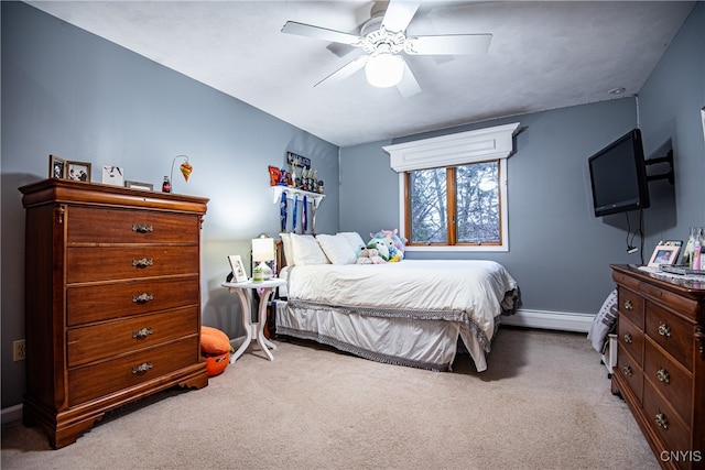 carpeted bedroom featuring ceiling fan and a baseboard heating unit