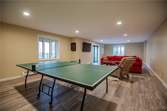 game room with baseboard heating and hardwood / wood-style floors