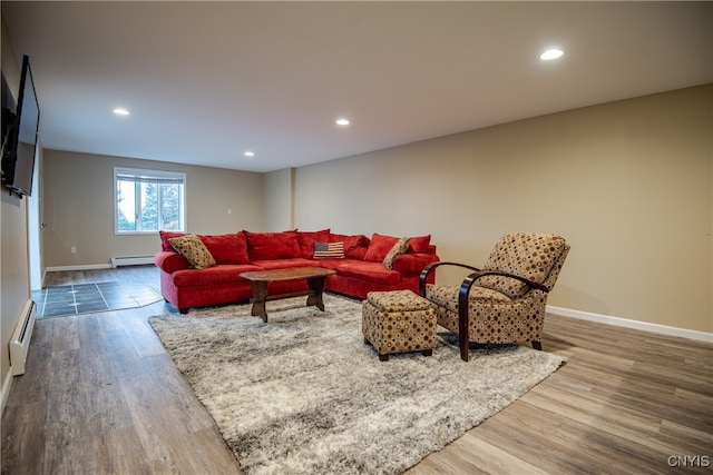 living room with hardwood / wood-style flooring and a baseboard heating unit